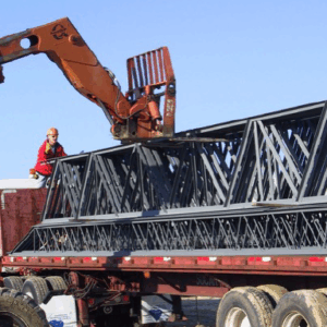 Unloading a Bundle of Joist Girders with a Fork Type Lift Typically Available on Construction Sites