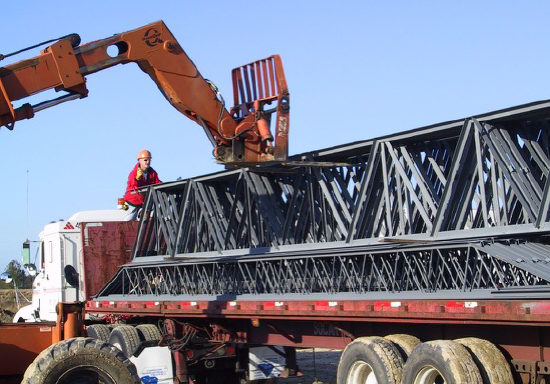 Unloading a Bundle of Joist Girders with a Fork Type Lift Typically Available on Construction Sites