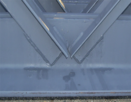 Angles welded to the outside of chords