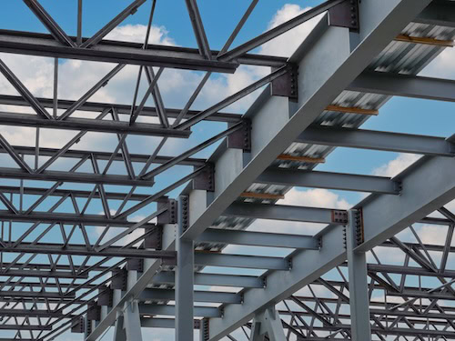 Flush frame steel joist connections to structural steel girders in a steel building framing system.